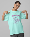 Teen girl wearing oversized graphic t-shirt with 'Cherry Bomb' design – streetwear style by YoungnCool-YnCLife