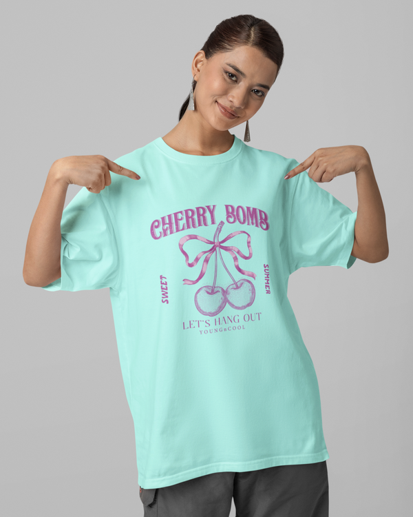 Teen girl wearing oversized graphic t-shirt with 'Cherry Bomb' design – streetwear style by YoungnCool-YnCLife