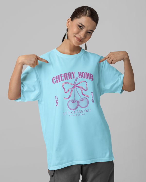 Teen girl wearing oversized graphic t-shirt with 'Cherry Bomb' design – streetwear style by YoungnCool-YnCLife