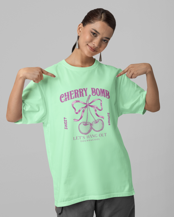 Teen girl wearing oversized graphic t-shirt with 'Cherry Bomb' design – streetwear style by YoungnCool-YnCLife