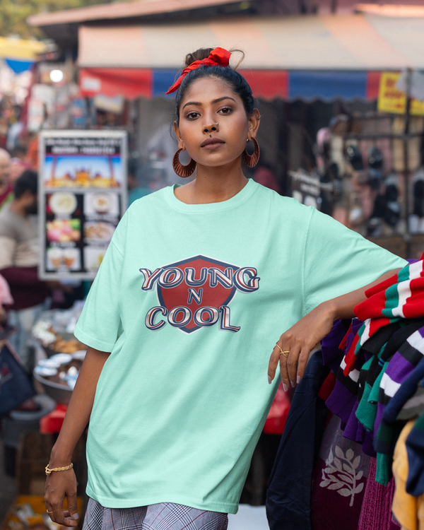 Teen girl wearing oversized graphic t-shirt with design – streetwear style by YoungnCool.