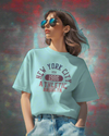 Teen girl wearing oversizedteal graphic t-shirt with 'New York City Print' design – streetwear style by YoungnCool.