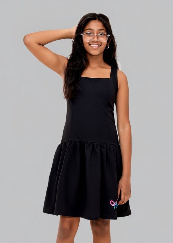 Woman wearing a black dress with a small design on a gray background